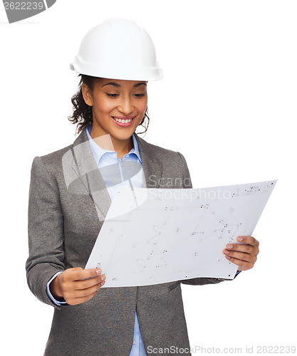 Image of businesswoman in white helmet with blueprint