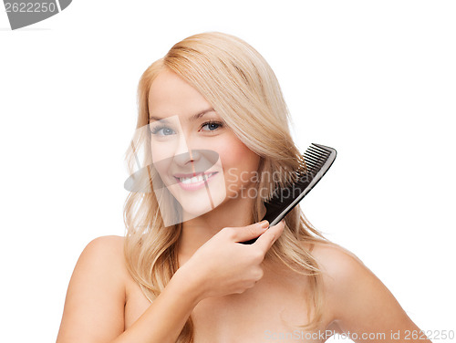 Image of smiling woman with hair brush