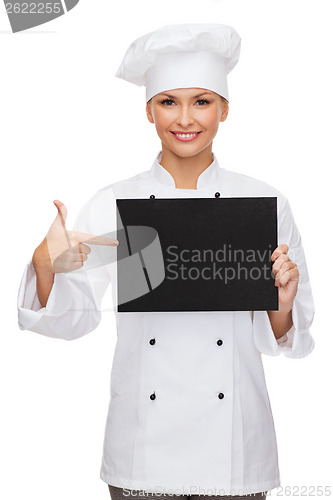 Image of smiling female chef with black blank paper