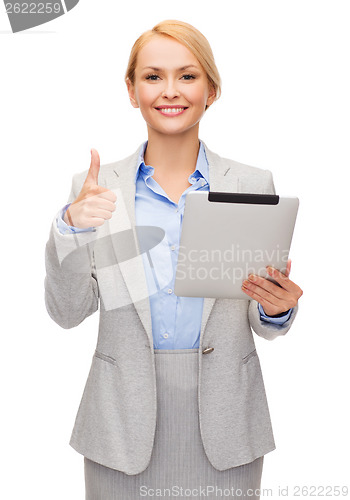 Image of smiling woman with tablet pc showing thumbs up