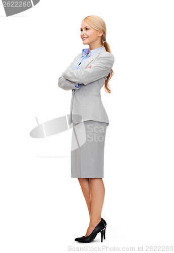 Image of smiling businesswoman with crossed arms