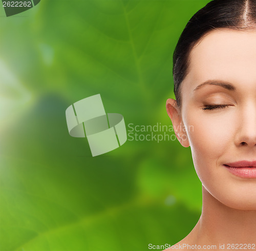 Image of young calm woman with closed eyes