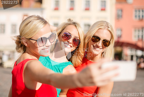 Image of girls taking picture with smartphone camera