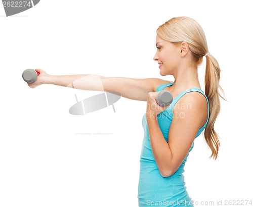 Image of young sporty woman with light dumbbells