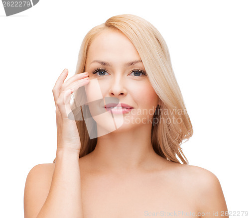 Image of beautiful woman touching her eye area