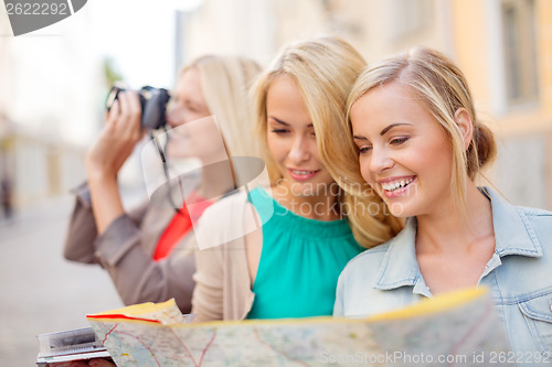 Image of beautiful blonde women with map in the city