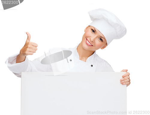 Image of smiling female chef with white blank board