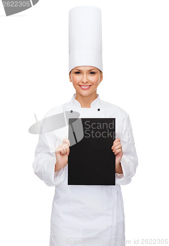 Image of smiling female chef with black blank paper