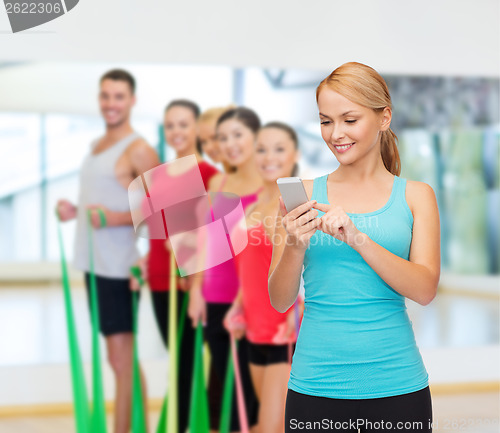 Image of sporty woman with smartphone