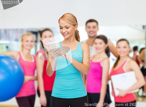 Image of sporty woman with smartphone