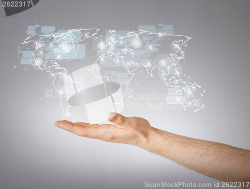 Image of mans hand showing world map