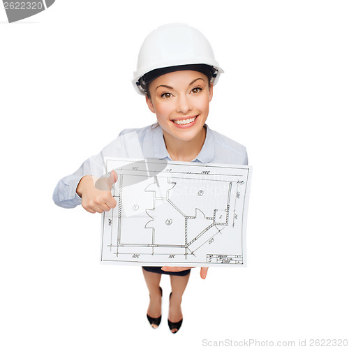 Image of businesswoman in helmet with blueprint