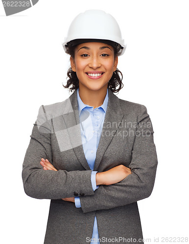 Image of businesswoman in white helmet with crossed arms