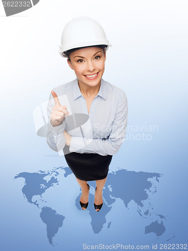Image of businesswoman in white helmet with finger up