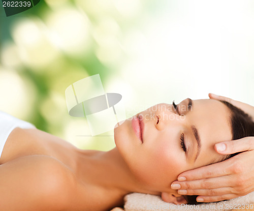 Image of beautiful woman in spa salon having facial