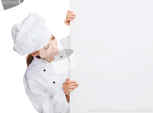 Image of smiling female chef with white blank board