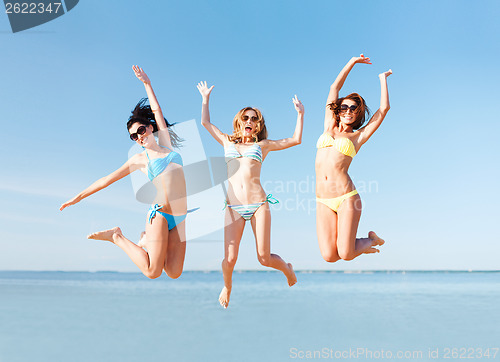 Image of girls jumping on the beach