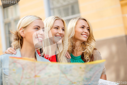 Image of beautiful blonde women with map in the city