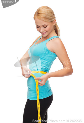 Image of sporty woman with measuring tape