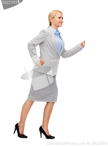 Image of smiling businesswoman running