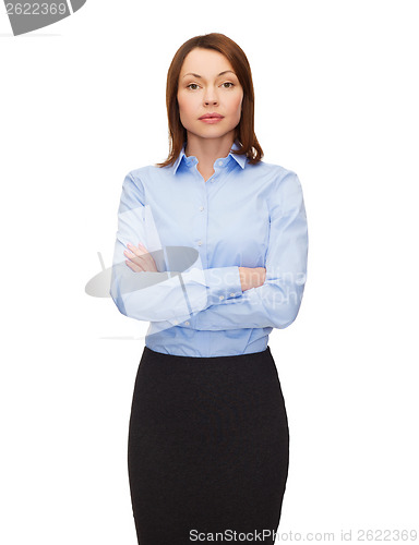 Image of smiling businesswoman with crossed arms