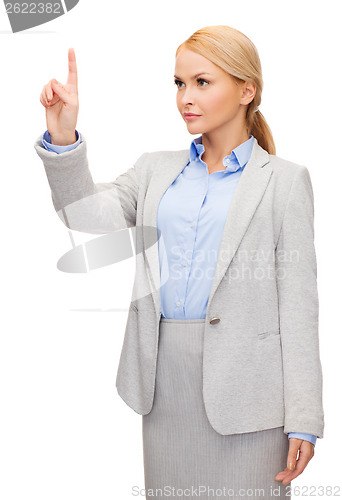 Image of smiling businesswoman working with virtual screen