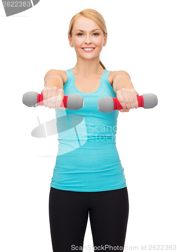 Image of young sporty woman with light dumbbells