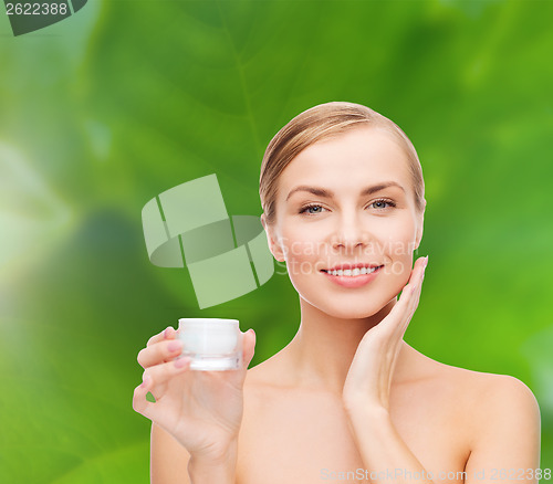 Image of woman applying cream on her skin