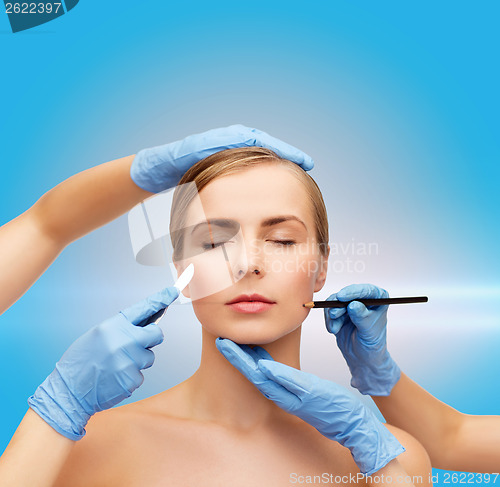 Image of woman face and beautician hands with pencil