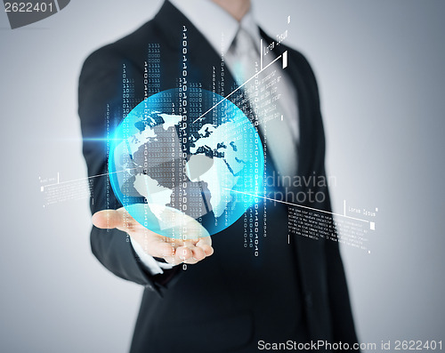 Image of businessmans hand showing earth globe