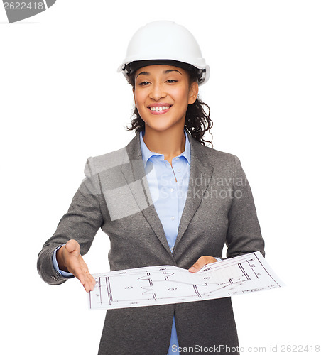 Image of businesswoman in white helmet with blueprint