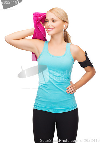 Image of sporty woman running with smartphone and earphones