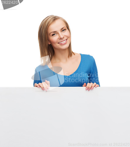 Image of smiling woman in sweater with blank white board
