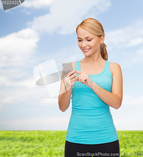 Image of sporty woman with smartphone