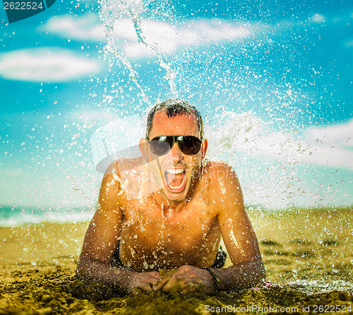 Image of sexy young man at the beach