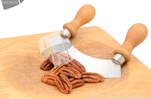 Image of Pecan nuts with a rocking knife