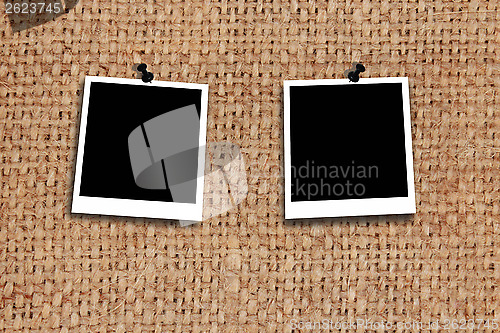 Image of two empty photos on the texture of grey sacking