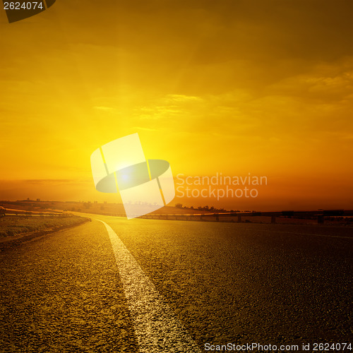 Image of golden sunset over asphalt road