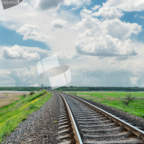 Image of railroad to horizon and cloudy sky