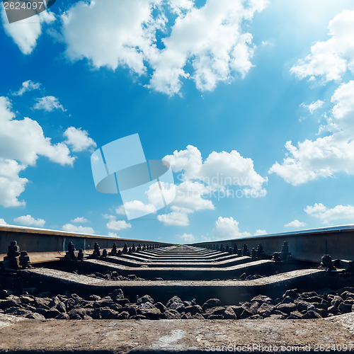 Image of railroad to horizon and clouds in blue sky