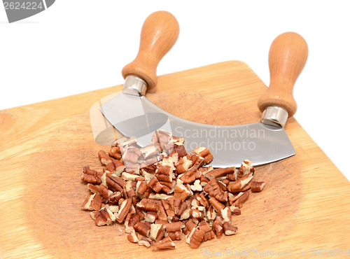 Image of Chopped pecan nuts with a rocking knife
