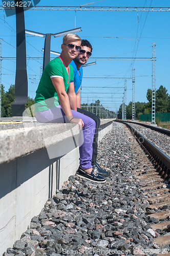 Image of Two men sitting on platform