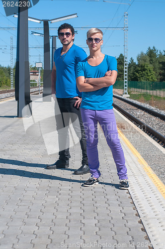 Image of Two men standing on platform