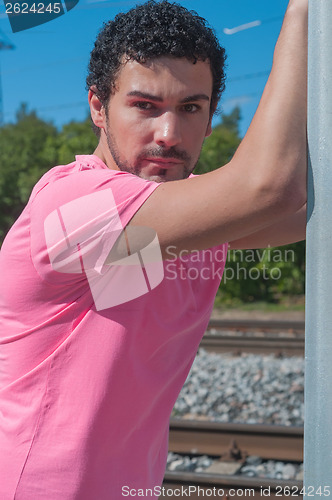 Image of Handsome young man in pink t-shirt