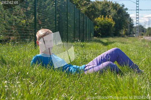 Image of Young man lying in a grass