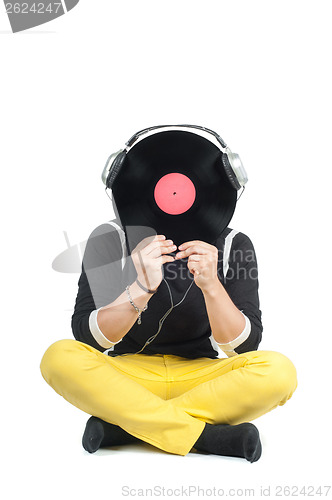 Image of Man hiding his face with vinyl record