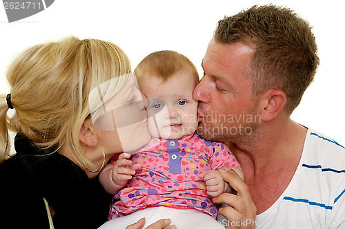 Image of Mother and father are kissing baby