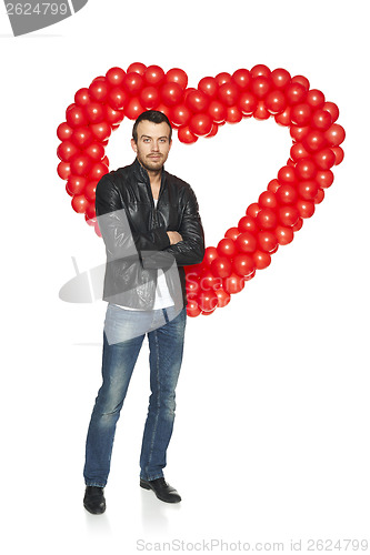 Image of Man standing in front of heart shape