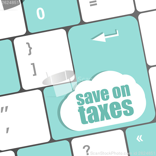 Image of save on taxes word on laptop keyboard key, business concept