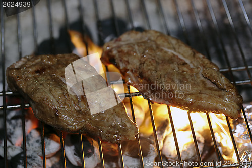 Image of Angus steaks on a barbecue
